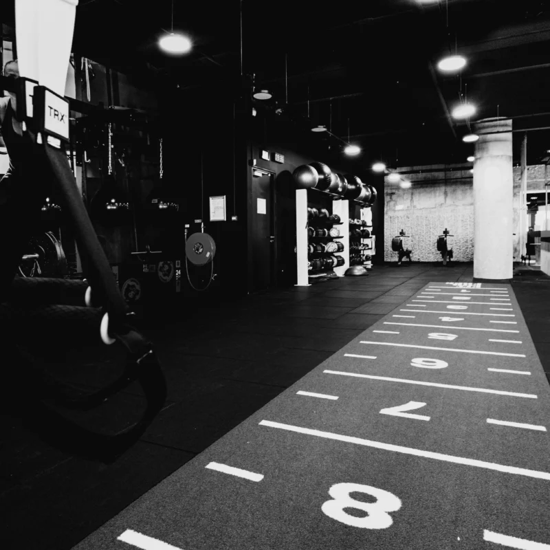 HYROX Style gym with the sled track in view and wall balls in the background