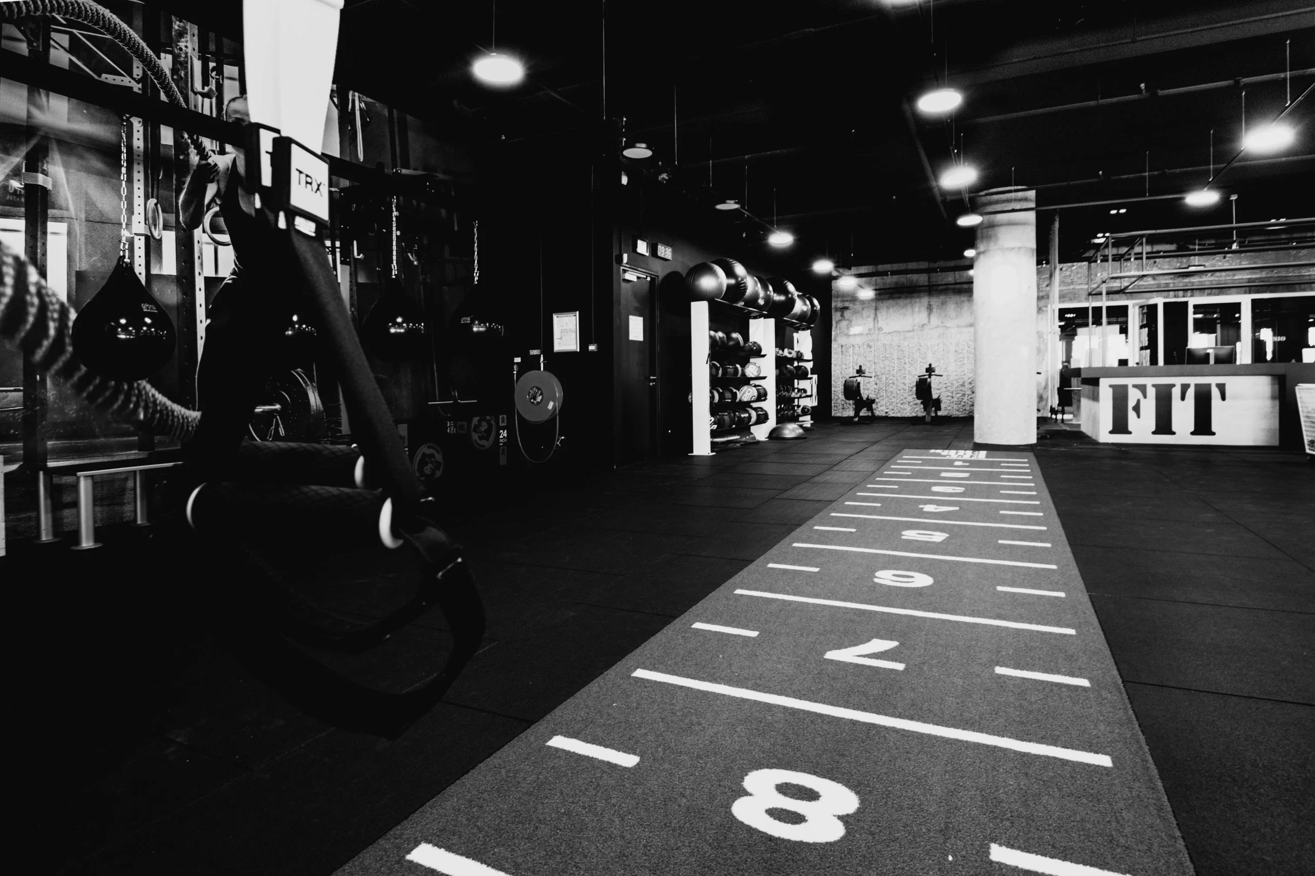 HYROX Style gym with the sled track in view and wall balls in the background